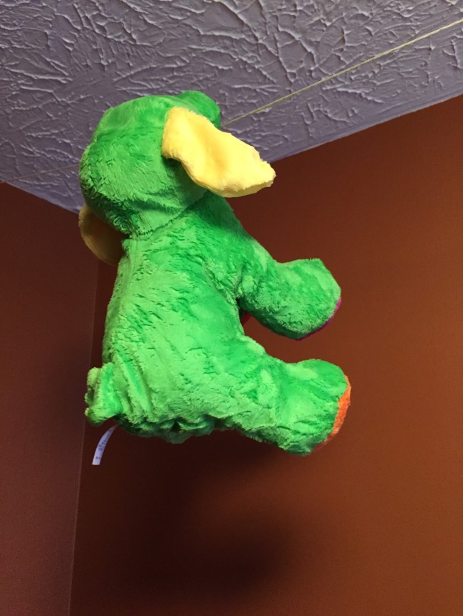 Pacifying Plush Puppy hanging from a clothesline