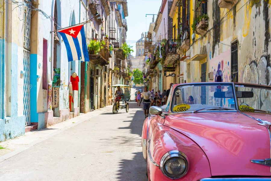 A street in Cuba, full of people and vibrant colors