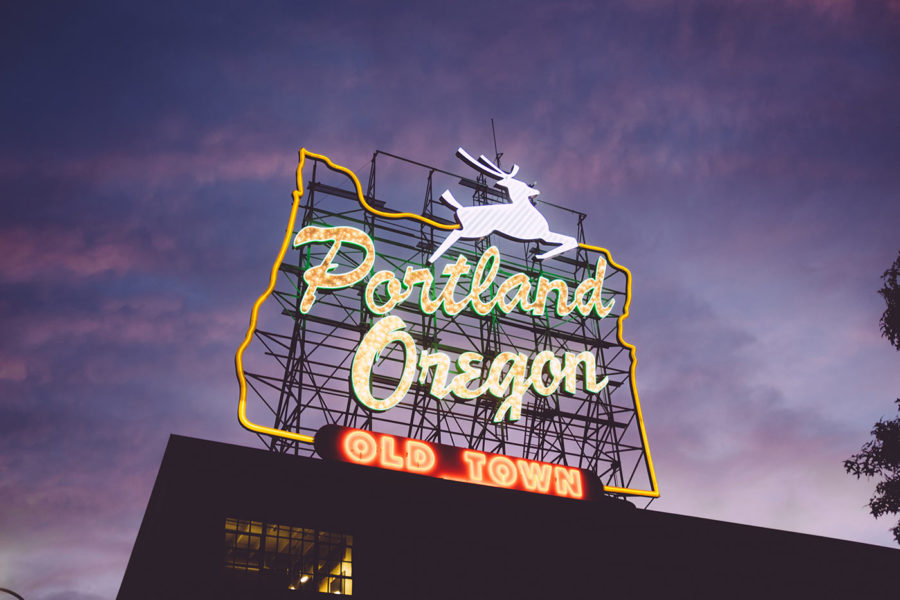 A stylized, neon "Portland, Oregon" Old Town sign