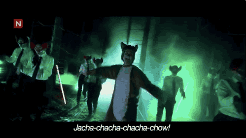 Adults in fox costumes dancing in the woods singing "Jacha-chacha-chacha-chow", from the popular "What Does the Fox Say?" music video.