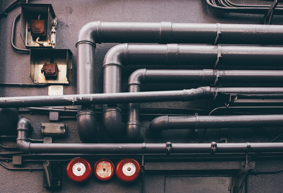 A series of pipes and gauges along a wall
