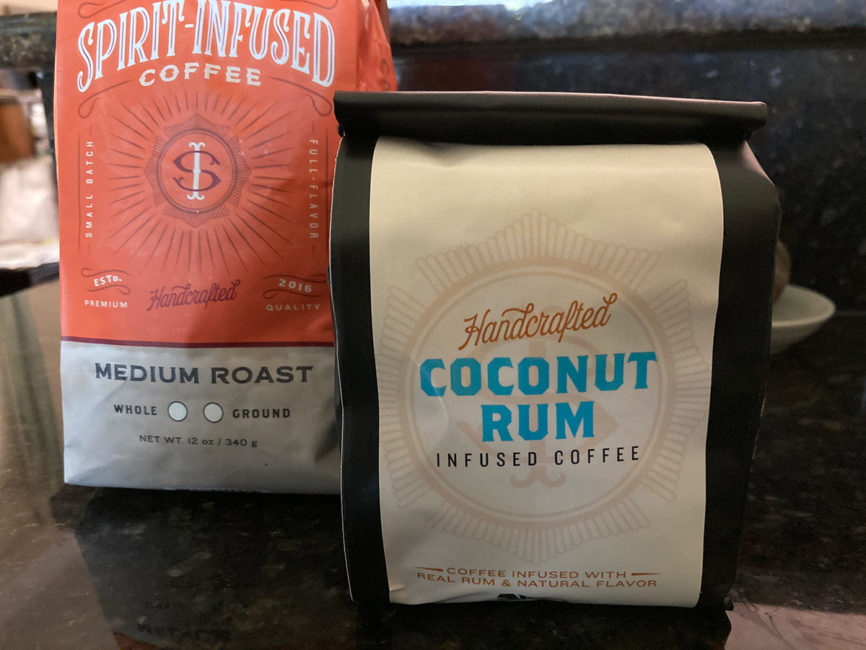Two bags of coffee from Fire Department Coffee: Coconut Rum and Maple Whisky infused coffees