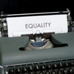 A typewriter with a sheet of paper reading "Equality"
