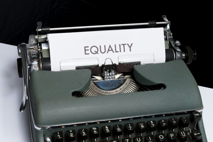A typewriter with a sheet of paper reading "Equality"