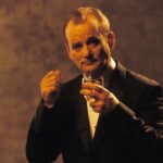 Bill Murray, wearing a suit and holding a glass of Suntory whisky, from a photoshoot in the film Lost In Translation (2003)