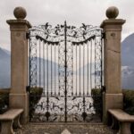 An ornate, metal gate overlooking a body of water